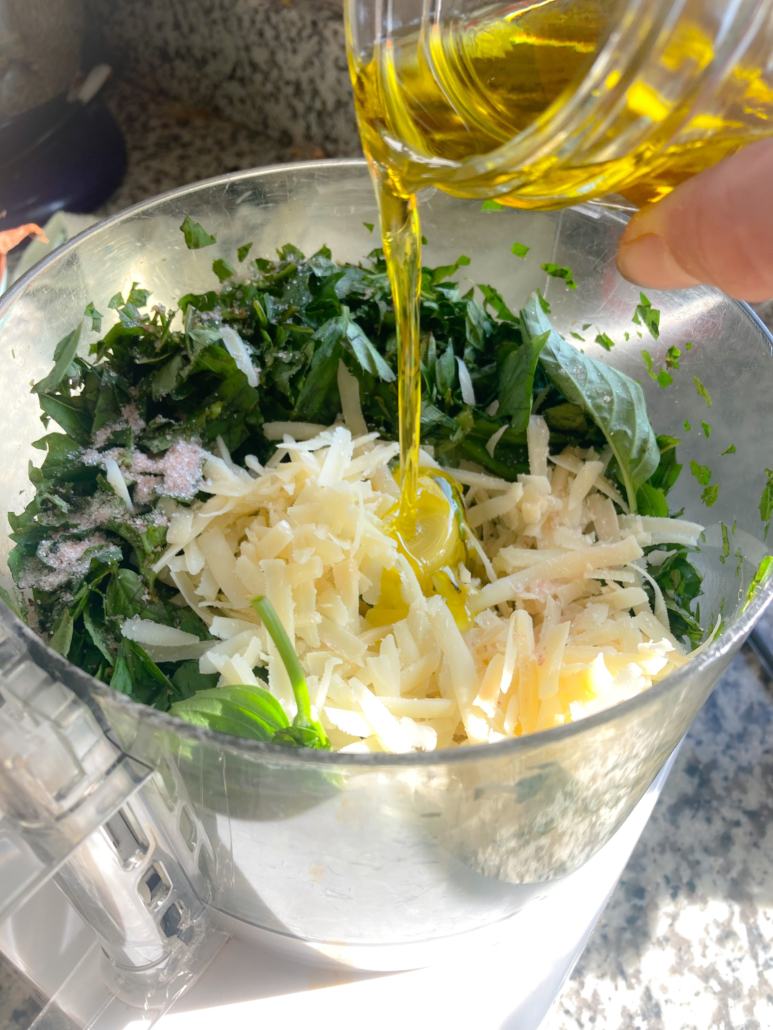 Pesto ingredients going in food processor